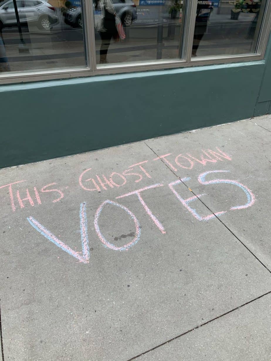 This Ghost Town Votes written in chalk on pavement