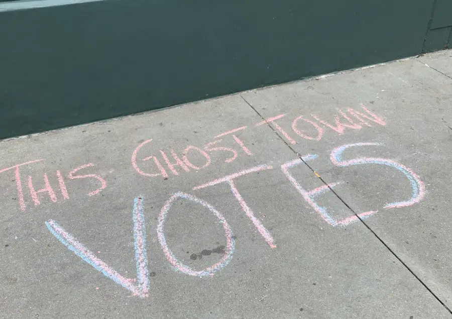 This Ghost Town Votes written in chalk on pavement