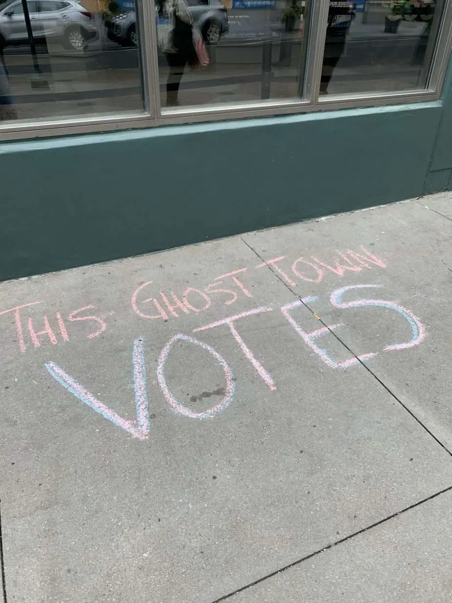 This Ghost Town Votes written in chalk on pavement